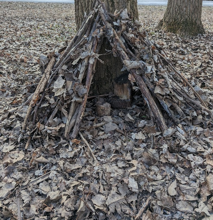 A small faerie house in the woods, built by my kids